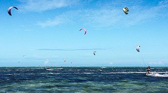 Kite surfers at Ilot Maitre, one of the best beaches in New Caledonia.