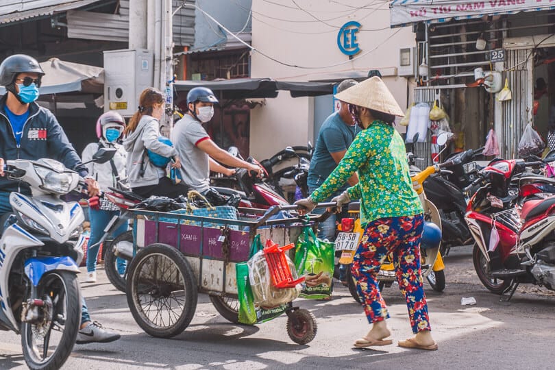 Local pushing a cart in Ho Chi Minh City.